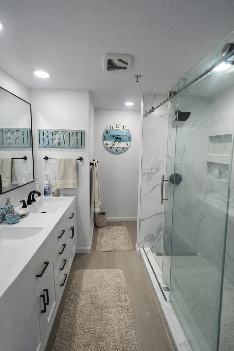 Bathroom with glass walk-in shower and dark vanity