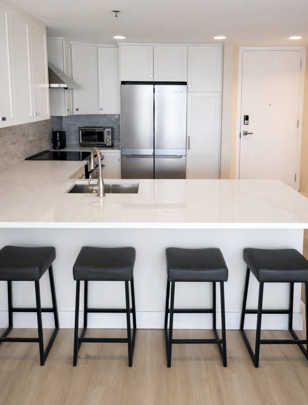 White condo kitchen with island seating
