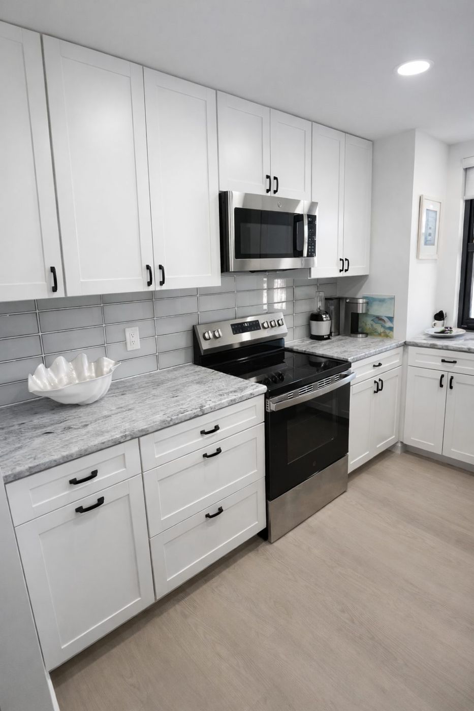 White shaker kitchen with stainless appliances