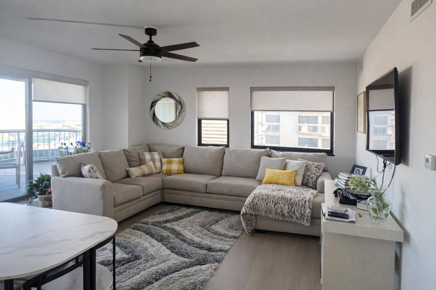 Bright condo living room with sectional sofa
