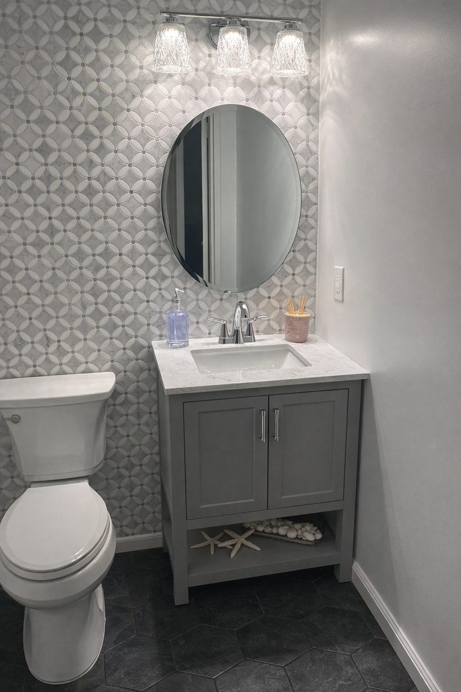 Grey powder room with patterned tile wall