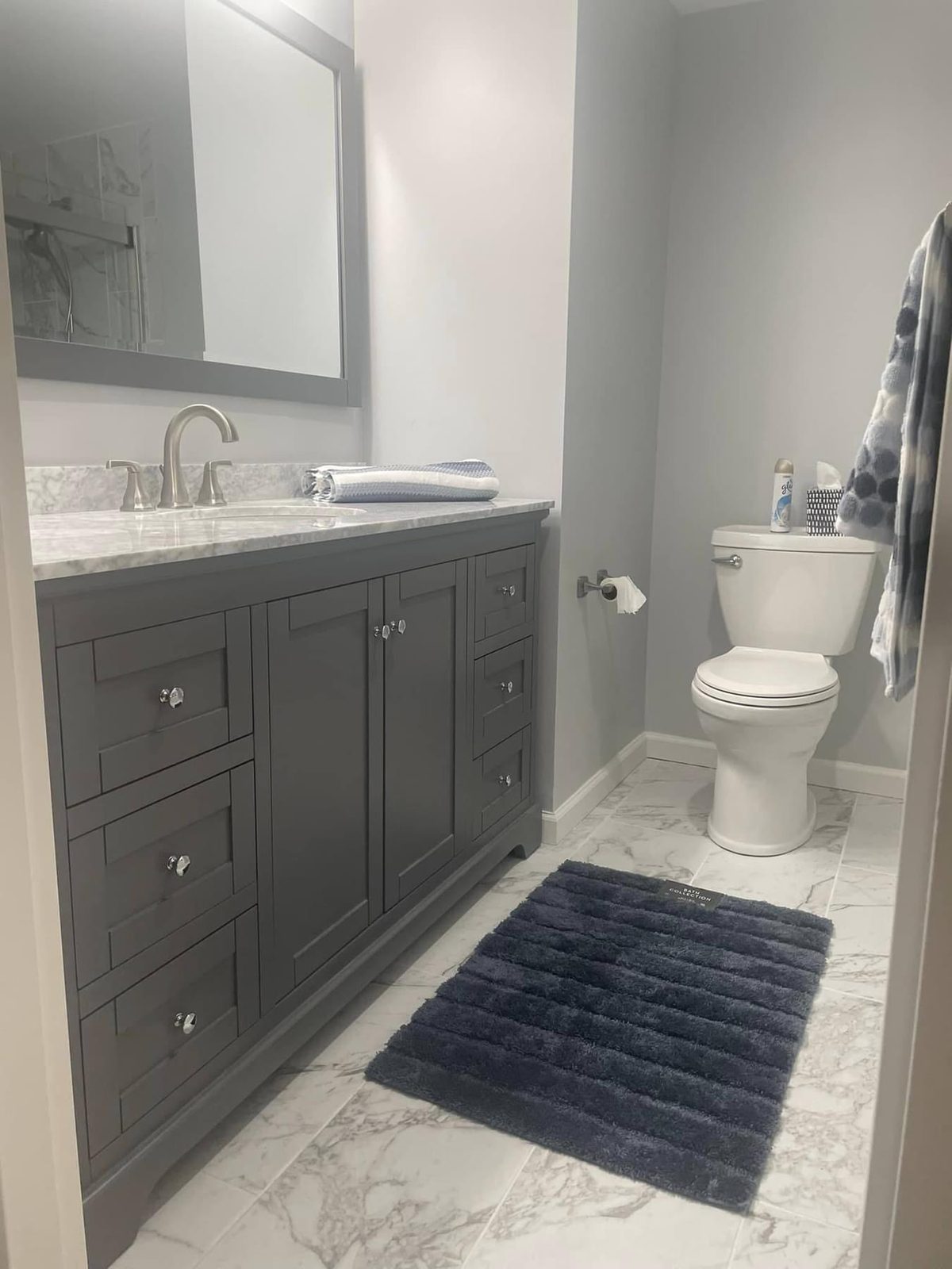 Gray shaker vanity with marble top, remodeled by Boardwalk Renovations