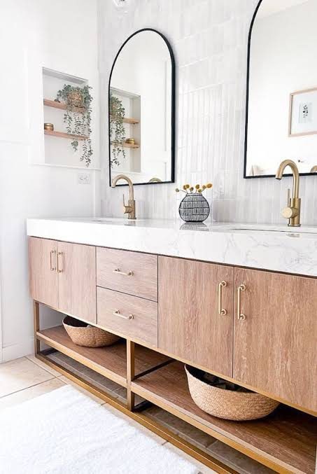 Floating wood vanity with white top, brass faucets and open shelf below, remodeled by Boardwalk Renovations