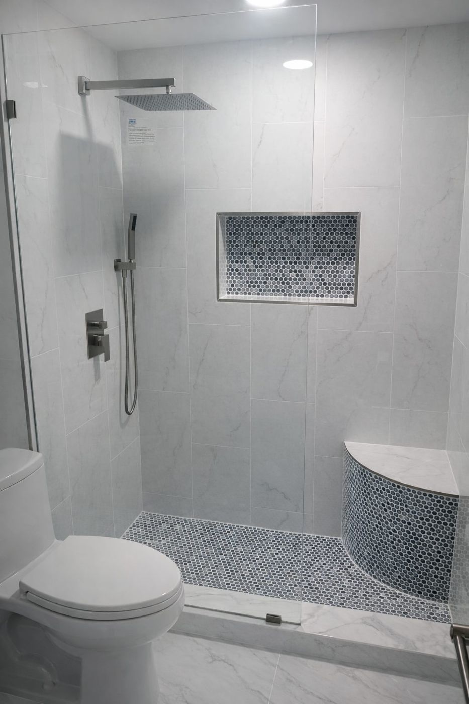 Tiled shower with mosaic niche and bench